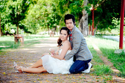 Portrait of young couple sitting in park