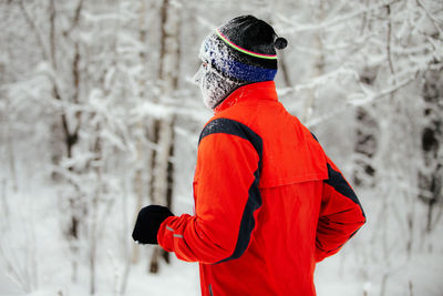 Midsection of person standing on field during winter