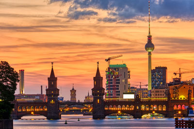 Dramatic sunset at the oberbaum bridge in berlin with the famous television tower in the back