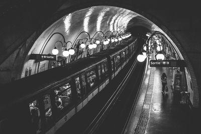 People in illuminated underground walkway