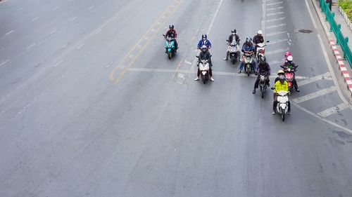 People riding bicycle on road in city