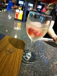 Close-up of hand holding drink on table in restaurant