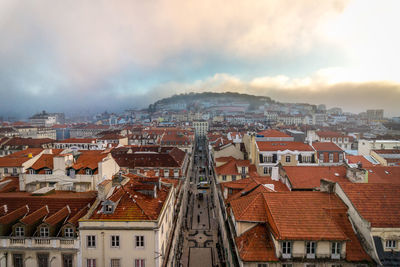 View of cityscape against cloudy sky