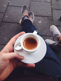 Low section of people holding coffee