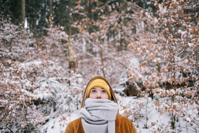 Portrait of woman in snow covered forest