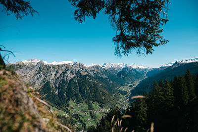 Scenic view of snowcapped mountains against blue sky