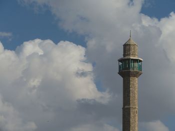 Low angle view of tower against cloudy sky