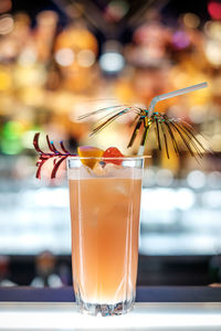 Close-up of singapore sling cocktail on bar counter