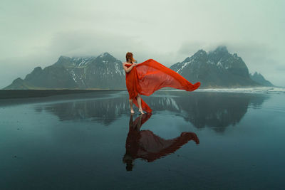 Attractive woman in chiffon dress on reynisfjara beach scenic photography