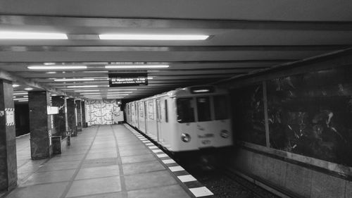 Train at illuminated railroad station platform