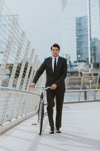 Full length of young man cycling in city