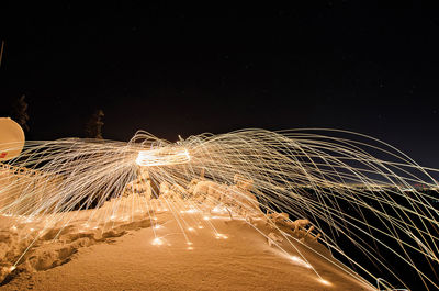 Light trails against sky at night