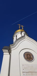 Low angle view of building against clear blue sky