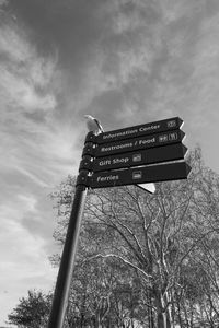 Low angle view of road sign against sky