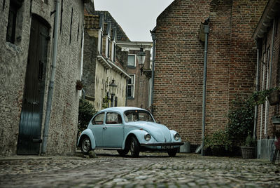 Car on street against buildings in city