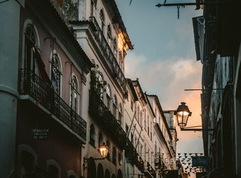 Low angle view of buildings in city at dusk