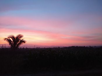 Scenic view of silhouette landscape against sky at sunset