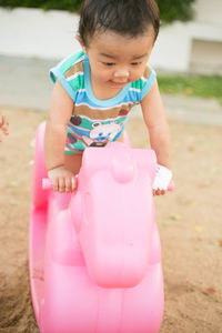 Cute girl playing with pink petals