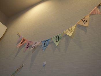 Low angle view of buntings with text hanging on wall