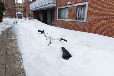 Snow covered houses by building
