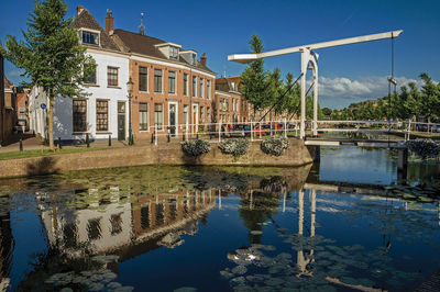 Reflection of trees and buildings in lake