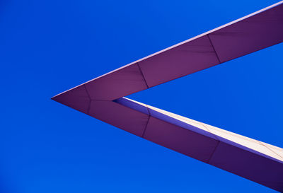 Low angle view of modern building against clear blue sky