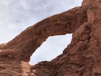 Low angle view of rock formation against sky