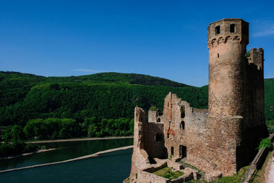 View of castle on mountain against blue sky