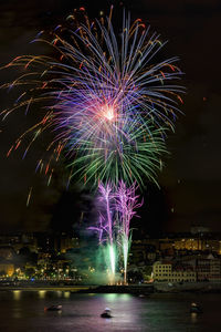 Firework display in city at night