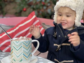 Portrait of happy boy holding umbrella