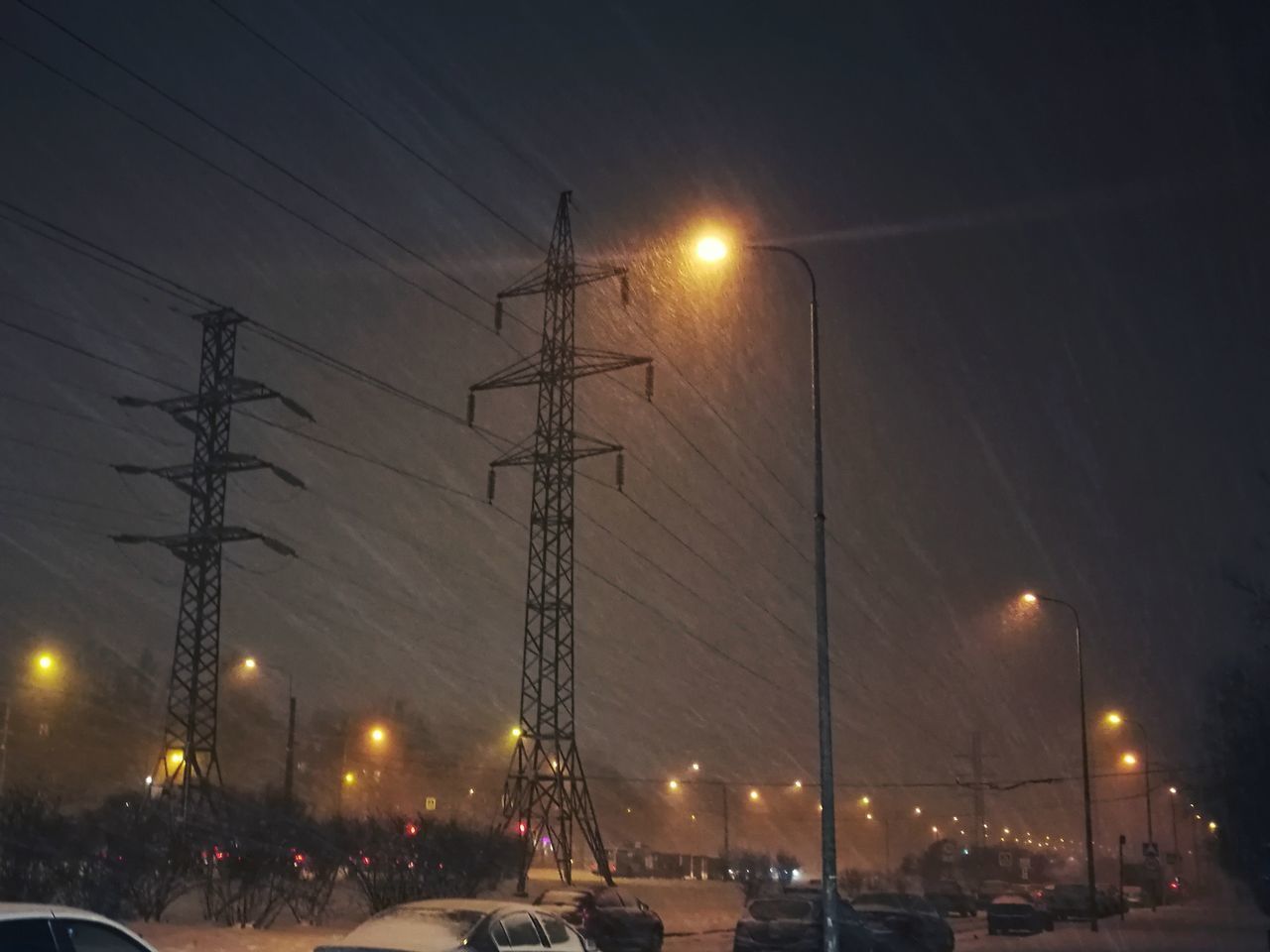 CARS ON ILLUMINATED STREET LIGHTS AT NIGHT