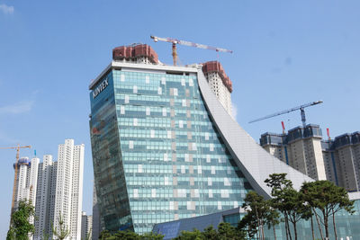 Low angle view of modern building against blue sky