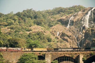 Scenic view of bridge over mountains against clear sky