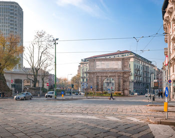 City street by buildings against sky