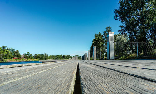 Road against clear blue sky