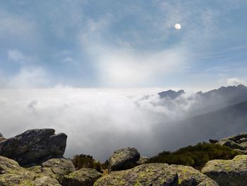 Mountain peak view with sea of clouds and morning moon