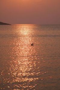 Scenic view of sea against orange sky