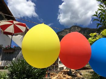 Low angle view of balloons against sky