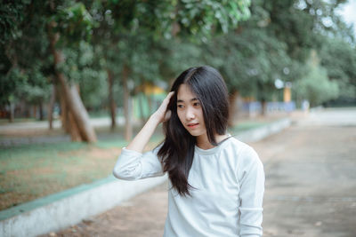 Smiling young woman standing outdoors