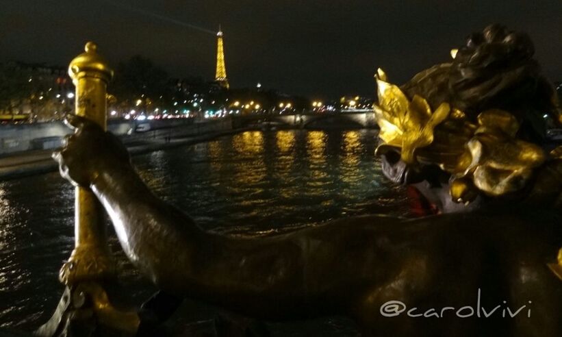 night, water, illuminated, river, built structure, architecture, city, building exterior, waterfront, transportation, bridge - man made structure, reflection, outdoors, travel destinations, statue, sky, famous place, sculpture, nautical vessel, travel