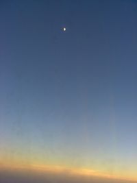 Low angle view of moon at sunset