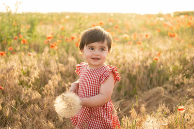 Smiling girl standing on flower filed