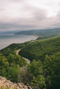 Scenic view of landscape and sea against sky