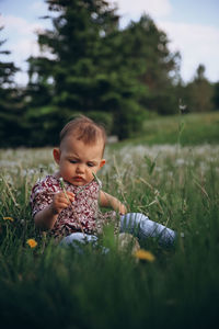 Portrait of cute girl sitting on grass