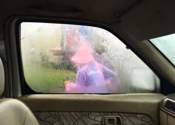 Reflection of man in car window