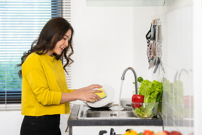 Young woman preparing food at home