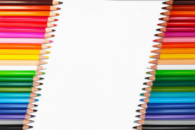 High angle view of multi colored pencils in row