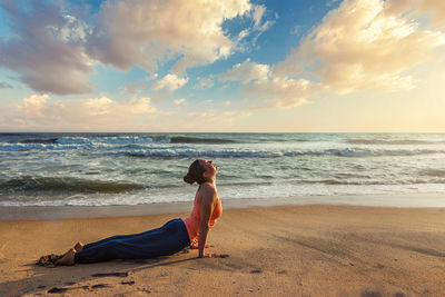 Full length of woman on beach against sky