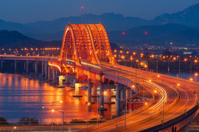 Illuminated banghwa bridge over han river at dusk