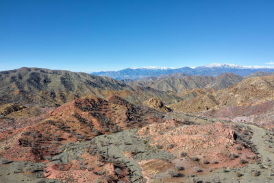 Scenic view of mountains against clear blue sky